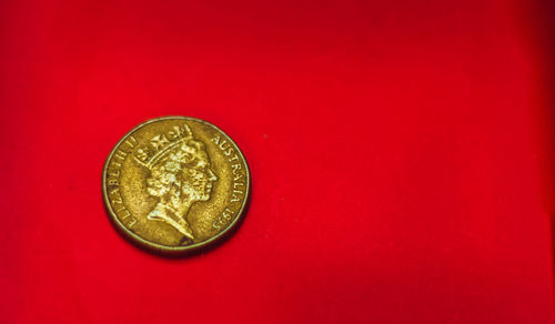 Close-up of coin against red background