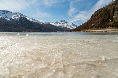Silvaplana, switzerland, feb21, 2023 panorama at the lake of silvaplana and the mount corvatsch 
