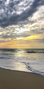 View of sea against cloudy sky during sunset