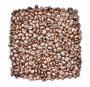 Directly above shot of coffee beans against white background