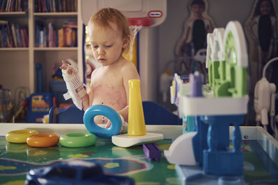 Cute boy playing with toy at home