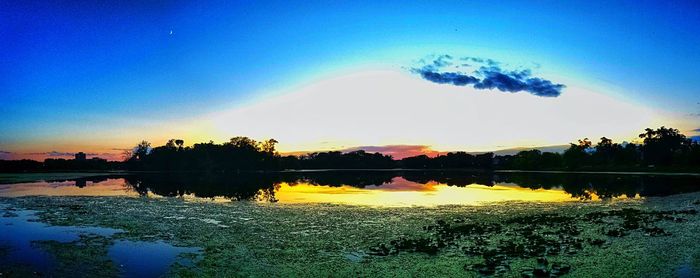 Scenic view of calm lake at sunset