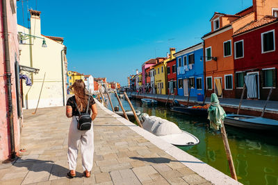 Rear view of people on footpath in canal