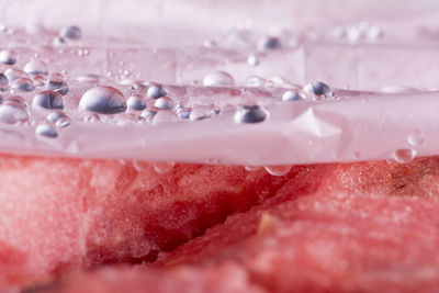 Background texture of a fresh juicy pink watermelon with condensation drops