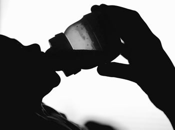 Low angle view of silhouette man photographing against sky