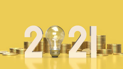 Close-up of coins on table against yellow background