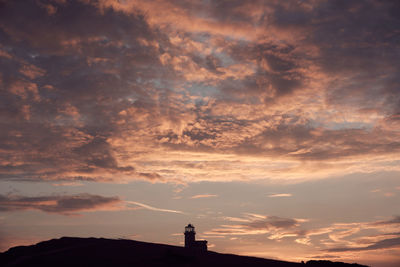 Low angle view of silhouette building against sky during sunset