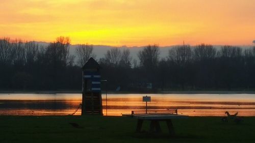 Scenic view of lake against orange sky