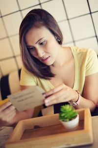 Young woman sitting on table