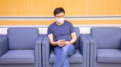 Boy sitting on sofa