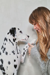 Young woman with dog in the background