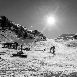 Tourists on snow covered mountain