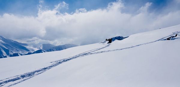 Scenic view of snowcapped mountains against sky