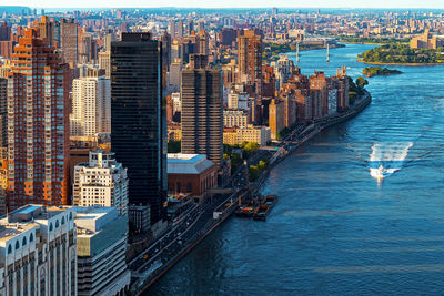 High angle view of buildings by river in city