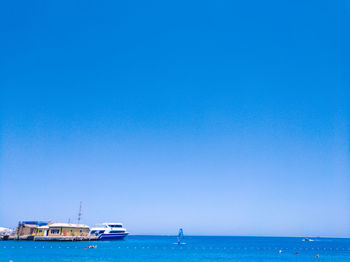 Scenic view of sea against clear blue sky