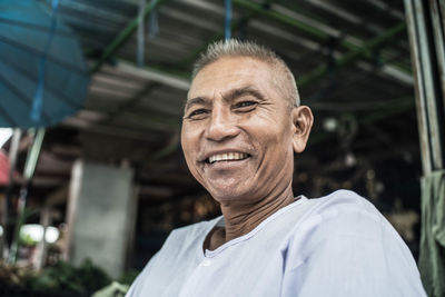 Portrait of happy vendor at market