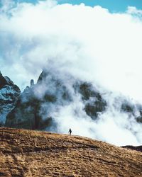 Man standing on mountain in foggy weather
