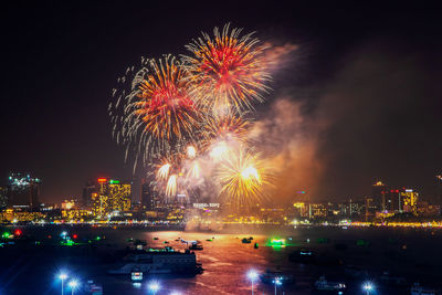 Fantastic and colorful fireworks display over the night sky of the city during a festival