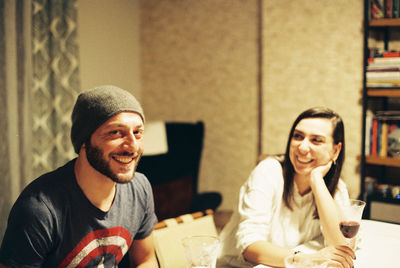 Portrait of smiling man with woman at restaurant