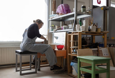 Woman preparing clay in workshop