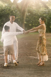 Rear view of couple walking in park