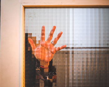 Midsection of person hand on glass