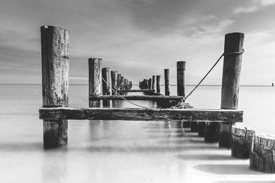 Pier over sea against sky in city