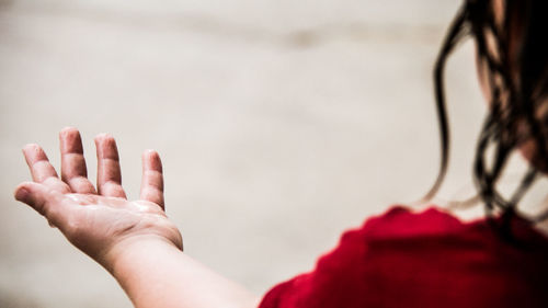 Close-up of woman hand against blurred background