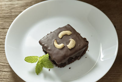 High angle view of chocolate cake slice in plate on table