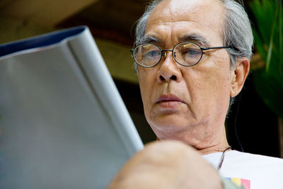 Close-up of senior man using digital tablet