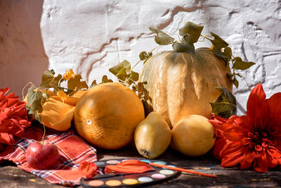 Autumn aesthetic fair yellow fruits, vegetables and bright paints, pumpkin, pears, apple and melon. 