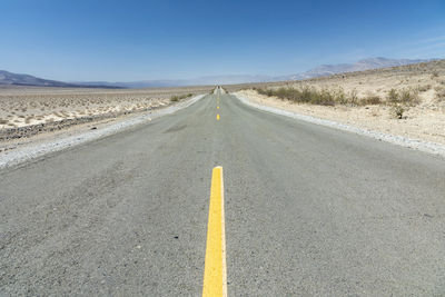 Empty road against clear sky