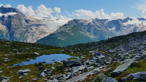 Scenic view of lake and mountains against sky