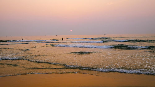 Scenic view of beach against sky during sunset