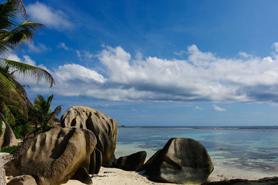 Rocks on beach against sky