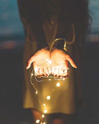 Close-up of hand holding illuminated light