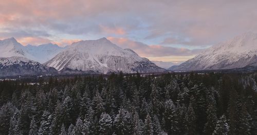 Scenic view of snowcapped mountains against sky during sunset