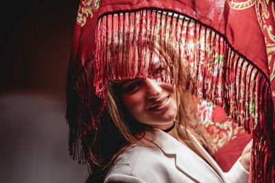 Portrait of young woman standing in lantern