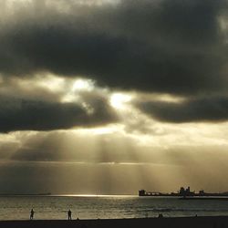 Scenic view of sea against storm clouds