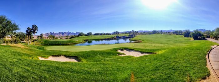 Scenic view of golf course against sky