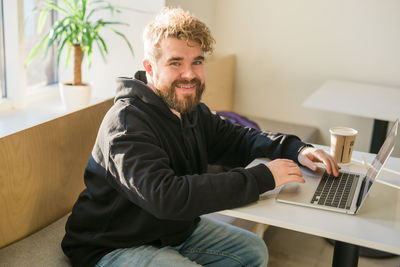 Young man using laptop at home