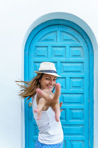 Carefree woman on tropical holidays reaching hand. woman on the beach on spanish travel destination.