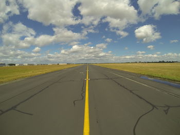 Road passing through landscape against sky