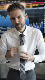 Portrait of businessman holding coffee cup