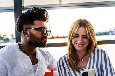 Portrait of an engaged multiethnic couple having fun on summer vacation on a river cruise ship