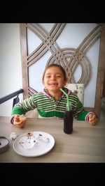 Portrait of smiling boy on table