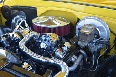 Close-up of yellow car engine in garage