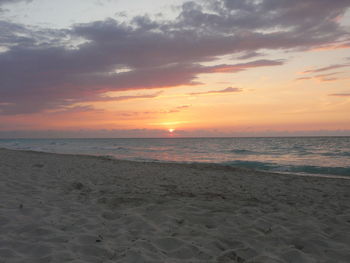 Scenic view of beach against sky during sunset