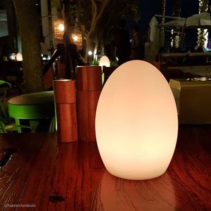 Close-up of illuminated lamp on table at night