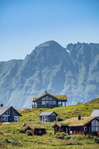 Houses on mountain against blue sky